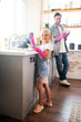 © zinkevych - Lovely daughter wearing pink gloves washing the dishes