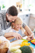 © zinkevych - Dad and his cute girl smiling while cooking together