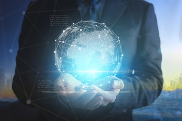 Close up of businessman hands showing digital planet.