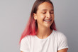 © fotofabrika - Young girl teenager with pink hair happy and smiling over gray background