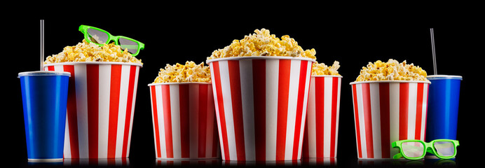 Canvas Print - Set of striped buckets with popcorn, cups of drink and glasses isolated on black