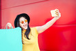 Happy Chinese girl making selfie with mobile smartphone outdoor - Asian social influencer woman having fun doing shopping - Concept of new generation youth lifestyle people and technology