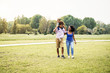 © Alessandro Biascioli - Happy African family walking together in public park - Mother father and baby daughter having fun spending time together outdoor - Happiness, love and parenthood concept