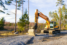 Yellow Excavator Building A Road Deep In The Forest. Rusko, Finland.