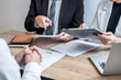 © Ngampol - Employer or committee holding reading a resume with talking during about his profile of candidate, employer in suit is conducting a job interview, manager resource employment and recruitment concept