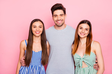 Wall Mural - Portrait of lovely one guy two girls looking with toothy smile wearing striped dress skirt striped t-shirt isolated over pink background