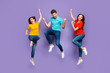 Full length size body photo of three group of people one handsome crazy guy and two beautiful emotional ladies celebrating triumph isolated violet background
