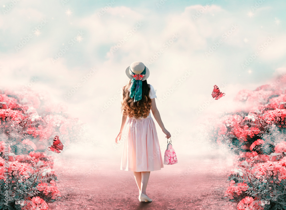 Young lady woman in romantic dress, hat with bag in retro style walking along summer rose field path and flying butterfly. Idyllic tranquil fantasy scene. Travel across fairy tale hills - obrazy, fototapety, plakaty 