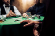cropped view of man cheating while playing poker on black with smoke