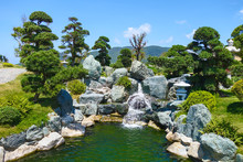 Little Waterfall Among The Stones In Asian Garden