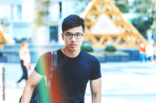 Young Handsome Asian Men Wearing Casual Plain Shirt And Backpack