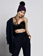 © Dmitry Lobanov - Glamorous stylish woman blonde in velvet bralet, blue pants and winter hat is posing with blue jacket on her shoulder