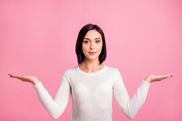 Photo of pretty sale manager lady presenting novelty on both arms offer to pick better product wear white pullover isolated pink color background