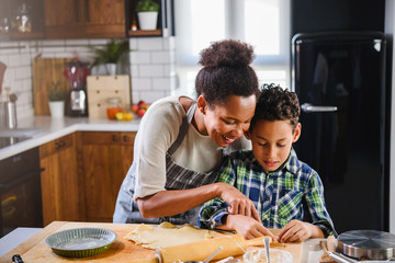 mother and son baking together. american family. single mother. child helping mother.