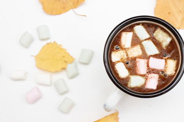 Wall Mural - white mug of coffee with marshmallows and yellow autumn leaves