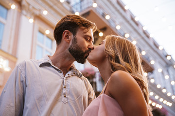 Poster - Loving couple walking by street outdoors kissing.