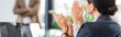 © LIGHTFIELD STUDIOS - panoramic shot of businesspeople in formal wear clapping in office
