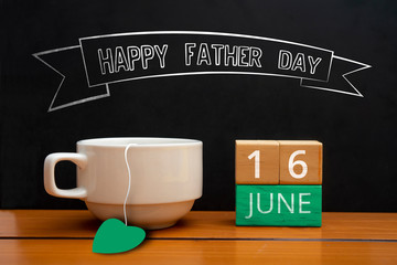 Text of happy fathers day with coffee cup on wooden background