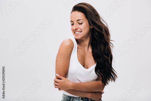 Cuadros en Lienzo smiling brunette beautiful woman with crossed arms and long healthy and shiny ha