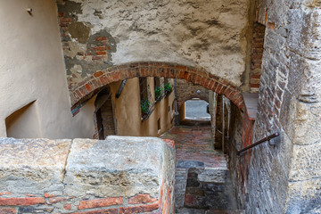 Wall Mural - Old Alley with stairs down to the underpass