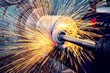 © andov - Grinding a cylindrical part on a circular grinding machine, high-precision abrasive grinding with sparks.