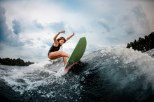Female Wakesurfer Performs Stunts On A Board