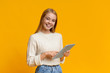 © Prostock-studio - Smiling teenage girl holding digital tablet and looking to camera