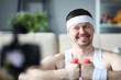 © H_Ko - Cheerful Blogger with Dumbbells in Hands Portrait. Smiling Sportsman Recording Fitness Exercise on Digital Camera for Sport Blog. Happy Male Practice Aerobic Training in Apartment. Healthy Lifestyle