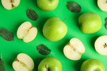 Flat Lay Composition Of Fresh Ripe Apples On Green Background