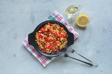 Wall Mural - Chorizo orzo salad with roasted pepper, red onion and cherry tomatoes. Top view, copy space.