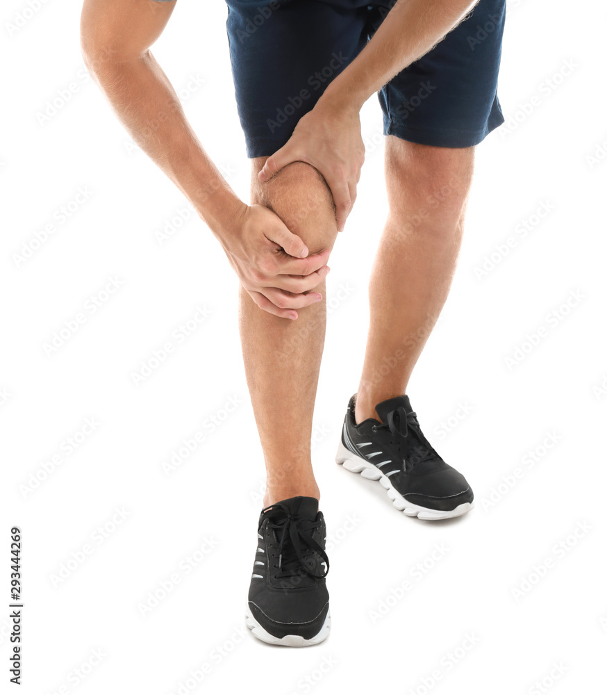 Young man suffering from pain in knee on white background
