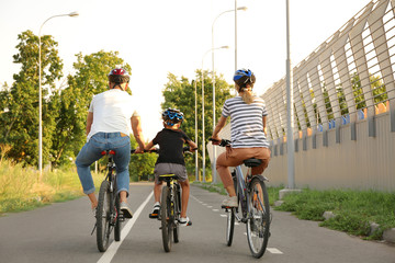 Poster - Happy family riding bicycles outdoors