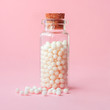 Close-up image of homeopathic globules in glass bottle on pastel pink background. Alternative homeopathy medicine herbs, healthcare and pills concept