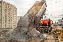 Construction Truck Tipping Dumping Gravel On Road Construction Site,tip Truck And Ripper At Work Preparing Ground For New Housing Estate,Dump Truck Unloading Process,