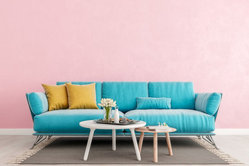 Living room millennial pink interior wall mock up with light blue sofa, empty white wall with free space above on top, 3D render, 3D illustration