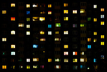 Flat Night Panorama Of Multicolor Light In Windows Of Multistory Buildings. Life In Big City