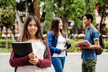 Latin female student, Hispanic girl in Mexico and group of mexican students at Background in Mexico