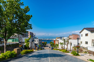 View of Hachiman-zaka Slope in summer sunny day white clouds and bule sky. A sloped street made famous in movies and commercials. Popular Sightseeing Spot in Hakodate City, Hokkaido, Japan