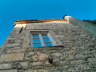 stone house building and blue sky in the old town