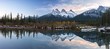 Three Sisters Snowy Mountain Peaks Reflection in Calm Water Wide Panoramic Landscape near Canmore, Alberta Foothills of Canadian Rocky Mountains