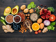 Ingredients for the healthy foods selection on dark background. Balanced healthy ingredients of unsaturated fats and fiber for the heart and blood vessels.