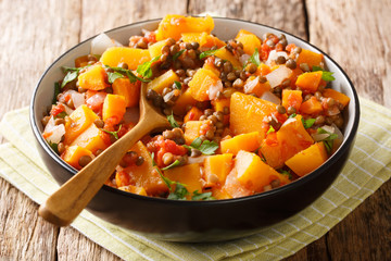 Low-calorie hot stew of pumpkin, lentils, onions and carrots close-up in a bowl. horizontal