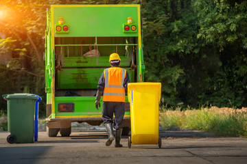 Wall Mural - Recyclable garbage truck and the keeper  in the village.