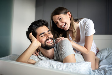 Wall Mural - Cheerful young couple making massage at home