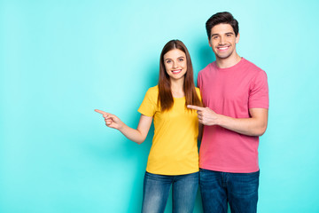 Poster - Portrait of his he her she nice attractive lovely cheerful cheery content couple hugging pointing aside ad advert solution isolated over bright vivid shine vibrant green turquoise background