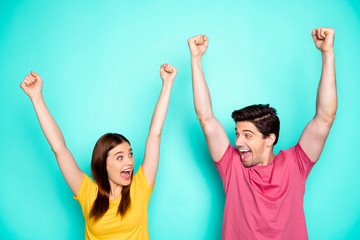 Poster - Portrait of his he her she nice attractive overjoyed crazy ecstatic cheerful cheery couple celebrating breakthrough rising hands up isolated over bright vivid shine vibrant green turquoise background