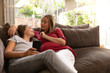 Young pregnant mother enjoying time at home with her daughter