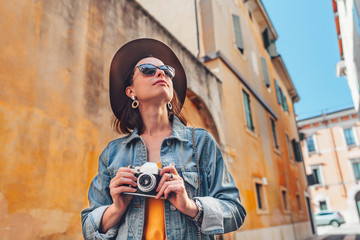 Wall Mural - Attractive photographer with a retro camera outdoors