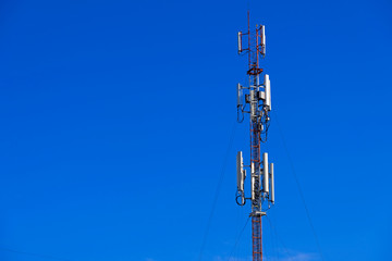 Telecommunication telephone signal transmission tower with beautiful blue sky background