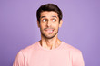 © deagreez - Close-up portrait of his he nice attractive funny confused brunet bearded guy wearing pink tshirt waiting news biting lip isolated over violet purple lilac pastel color background
